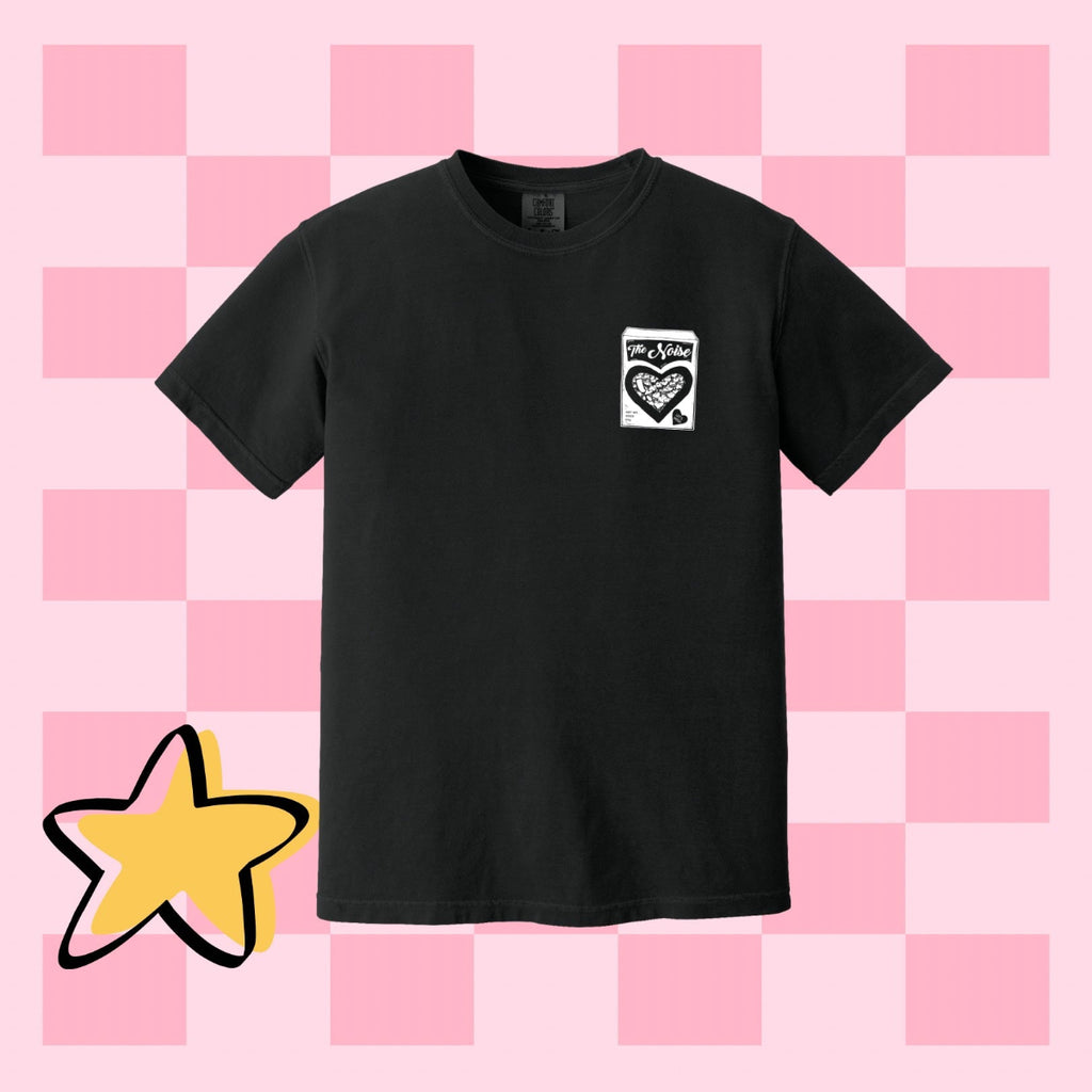 Black t-shirt with a small logo on a pink checkered background