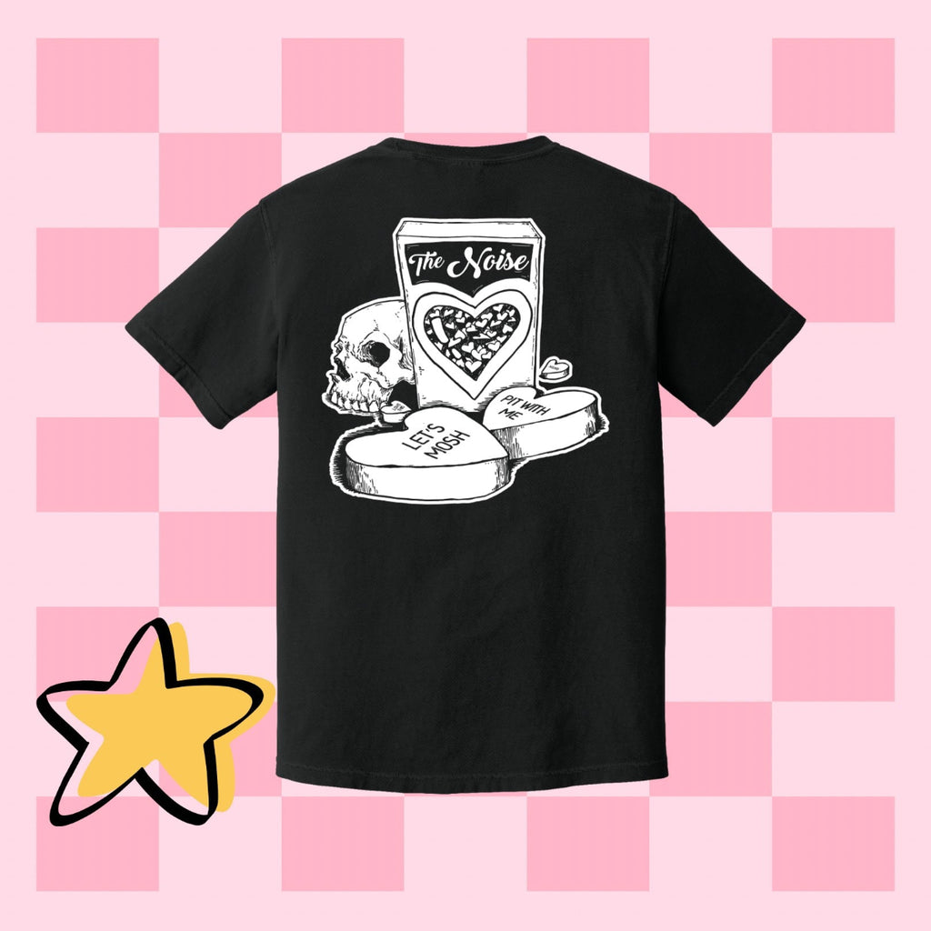 Black t-shirt with graphic design on a pink checkered background